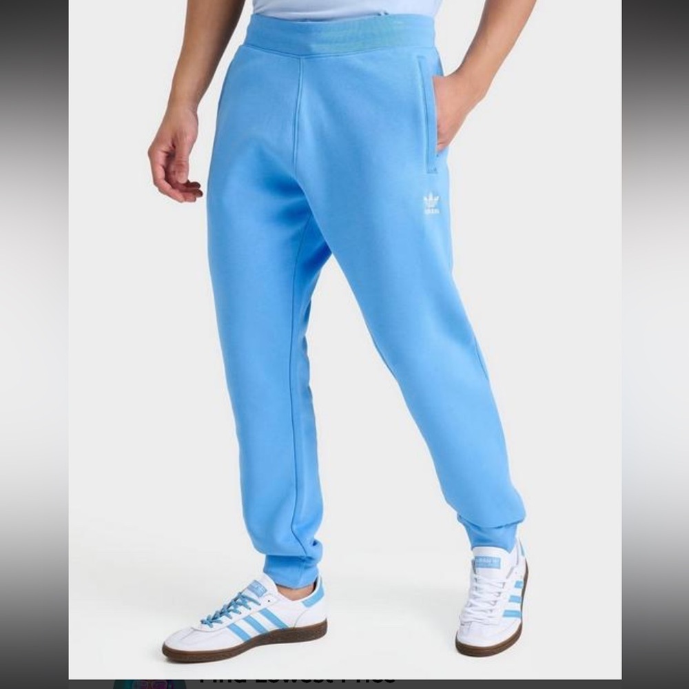 Men Adidas Essentials Light Blue Sweatpants with zippered pockets. Size XL NWT